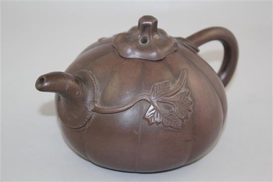 A Chinese Yixing melon-shaped teapot and cover, 19th / 20th century, length 18cm